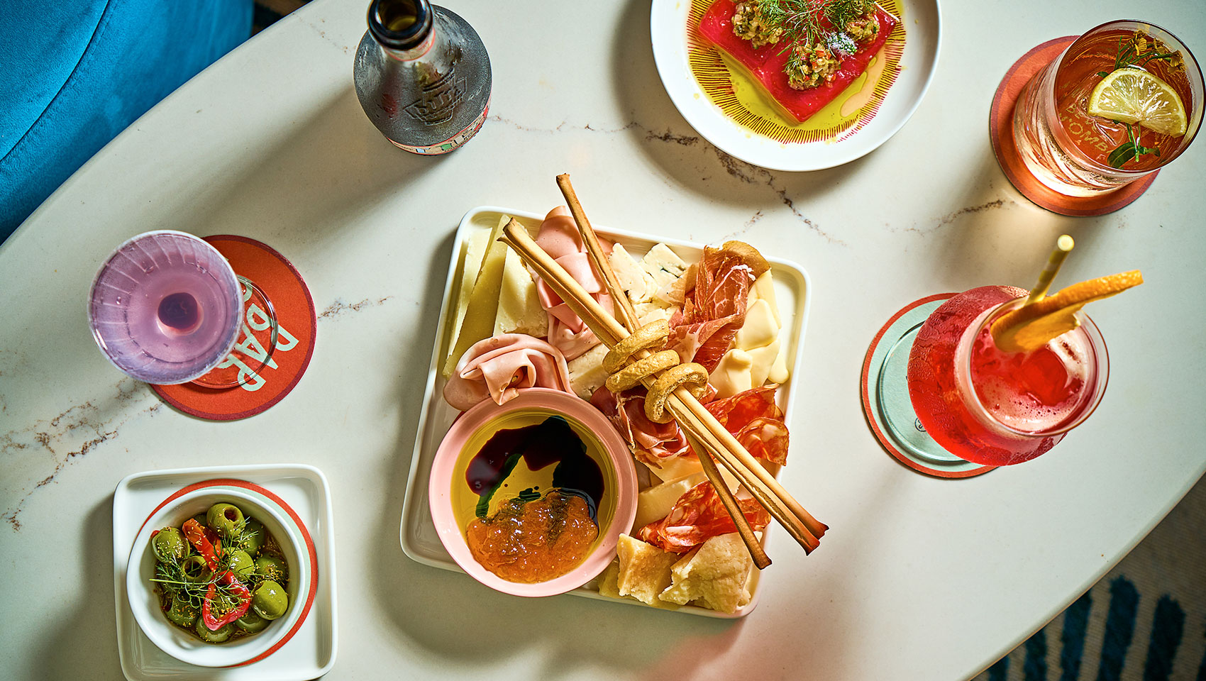 selection of snacks and cocktails shot from above at Bar Sprezzatura
